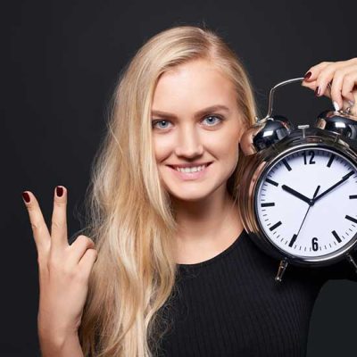 Woman With Clock Showing Two Minutes